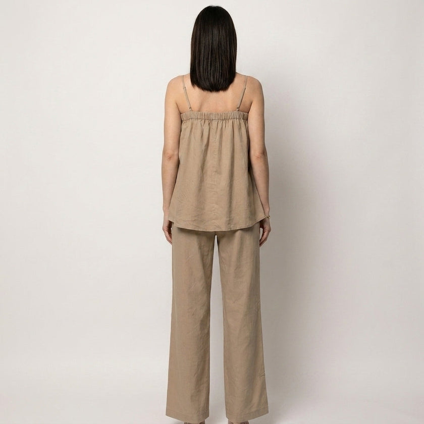 Back view of FJØRNA women's summer two-piece wide-leg co-ord set in lightweight fabric, featuring a cropped top and matching pants.
