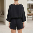 Back view of FJØRNA women's elegant two-piece lace co-ord set with pockets, featuring a Bardot neckline.