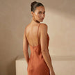 FJØRNA slim fit sleeveless maxi dress with cowl neck, shown from the back in soft fabric with elegant drape and fitted silhouette.