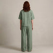 Back view of FJØRNA women's elegant two-piece drawstring co-ord set, featuring a stylish matching top and pants in a comfortable fit.