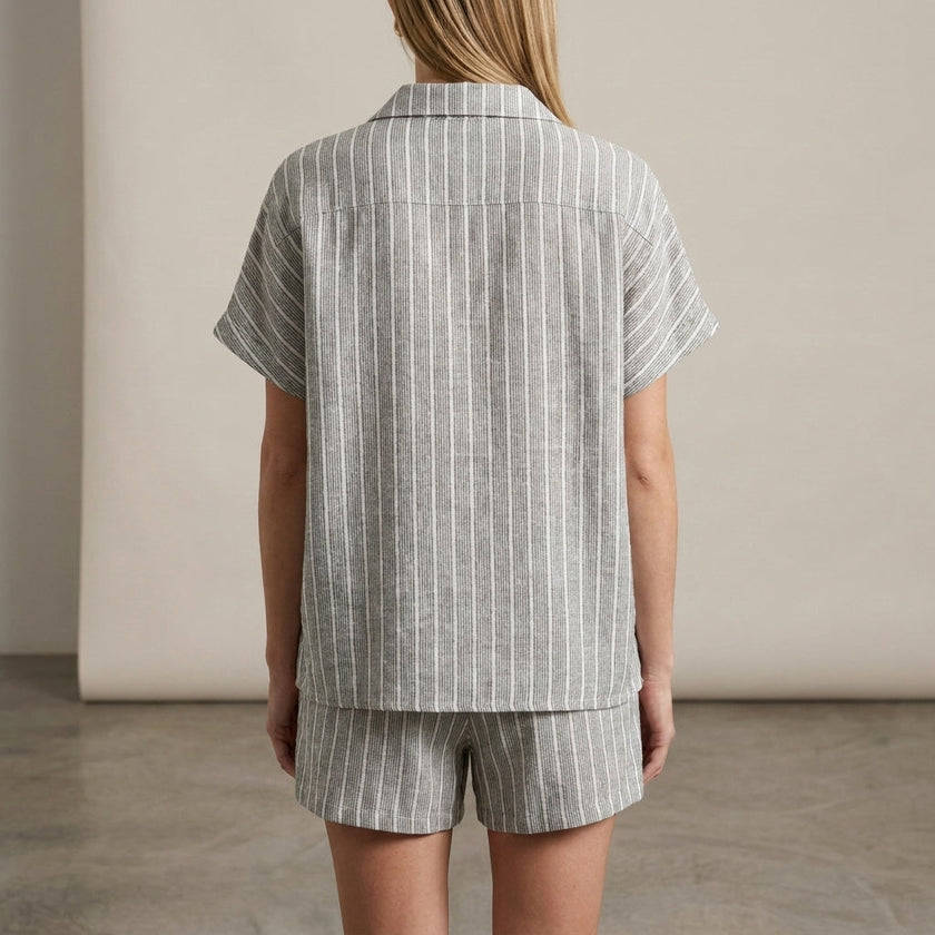 FJØRNA women's elegant two-piece striped co-ord set with button-front top and matching pants, shown from the back.