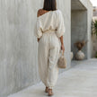 FJØRNA women's elegant two-piece co-ord set featuring a one-shoulder top with pockets, shown from the back.