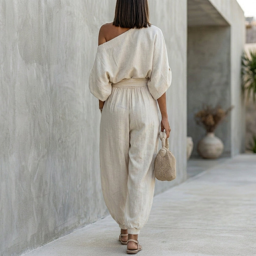FJØRNA women's elegant two-piece co-ord set featuring a one-shoulder top with pockets, shown from the back.
