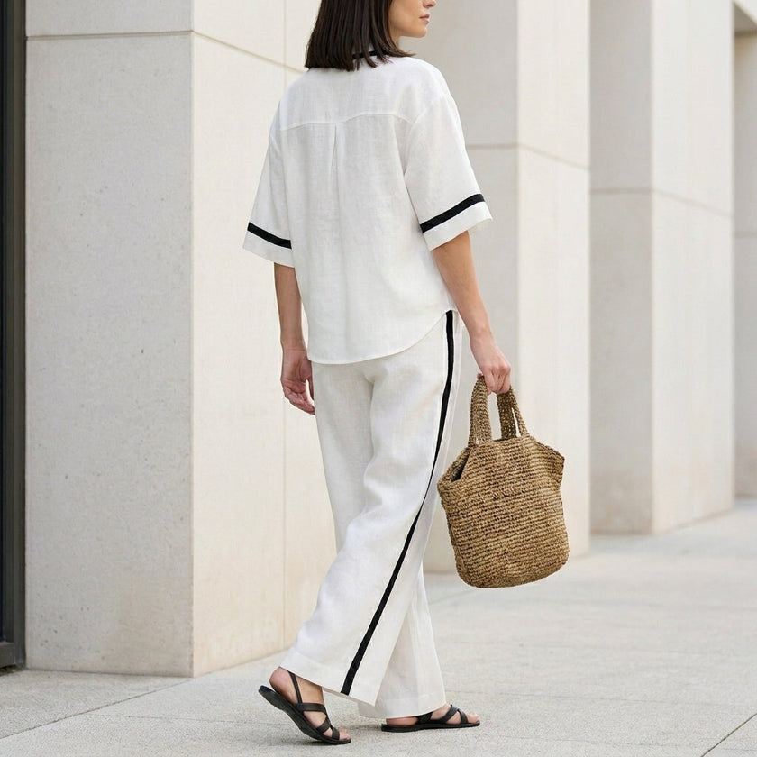 FJØRNA women's elegant two-piece co-ord set with wide-leg pants and V-neck top, shown from the back in soft fabric.
