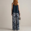 FJØRNA elegant two-piece women's co-ord set with print, wide-leg pants, and halter neck top, shown from the back.