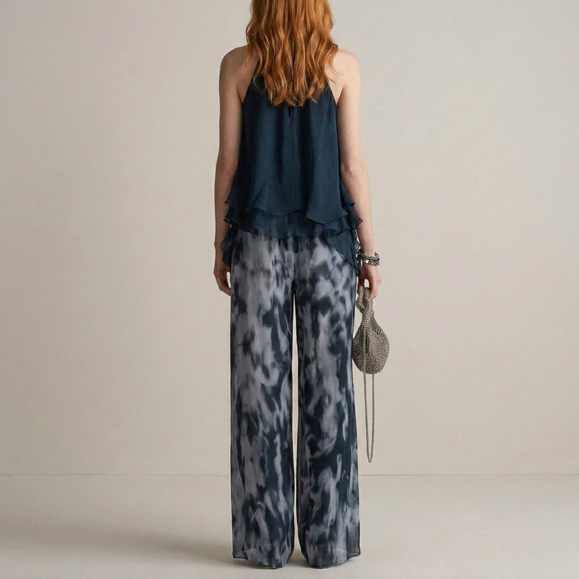 FJØRNA elegant two-piece women's co-ord set with print, wide-leg pants, and halter neck top, shown from the back.
