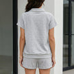 FJØRNA women's summer two-piece co-ord set with V-neck top and matching pants, featuring side pockets, shown from the back.