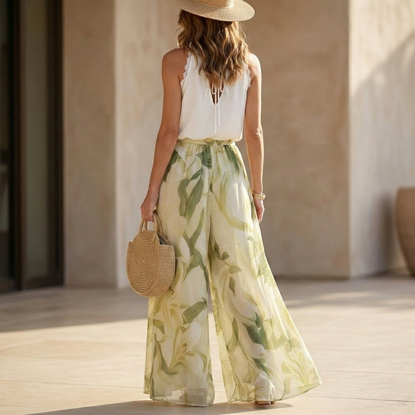 FJØRNA women's floral two-piece set with wide-leg pants and halter neck, shown from the back, stylish and elegant co-ord outfit.