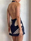 FJØRNA backless wrap front mini dress for women, stylish party and day wear, showcasing a fitted silhouette and elegant design.