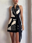 FJØRNA backless wrap-front women's mini dress showcasing a stylish party and day wear design with a fitted silhouette.