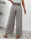 Beige FJØRNA lightweight summer women's wide-leg trousers made of breathable fabric, perfect for warm weather.