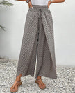 Beige FJØRNA women's lightweight summer trousers with wide leg design and breathable fabric, perfect for warm weather.