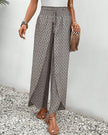 Beige lightweight summer trousers for women by FJØRNA, wide-leg breathable design, perfect for warm weather and casual wear.
