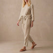 Beige women's linen two-piece co-ord set with pockets from FJØRNA, featuring a stylish and comfortable matching top and pants.