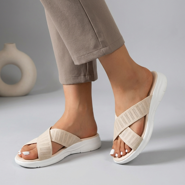 Beige women's orthopedic sandals by FJØRNA with adjustable straps and criss-cross design, showing the comfortable sole and open toe style.