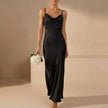 Black women's elegant maxi dress with cowl neck and cami straps by FJØRNA, showcasing a flowing, stylish evening wear silhouette.