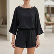 Black FJØRNA women's two-piece lace pocket Bardot co-ord set with fitted top and matching wide-leg pants.