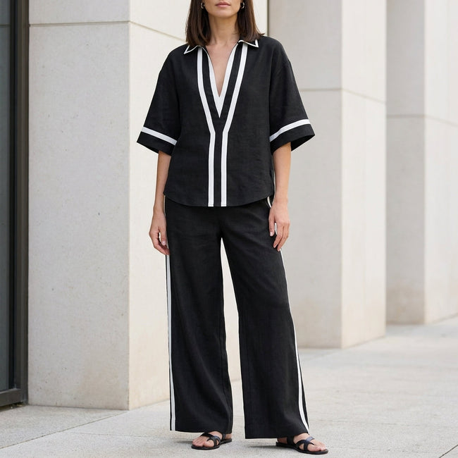 Black women's two-piece co-ord set by FJØRNA featuring a wide-leg pants and V-neck top, stylish and elegant.