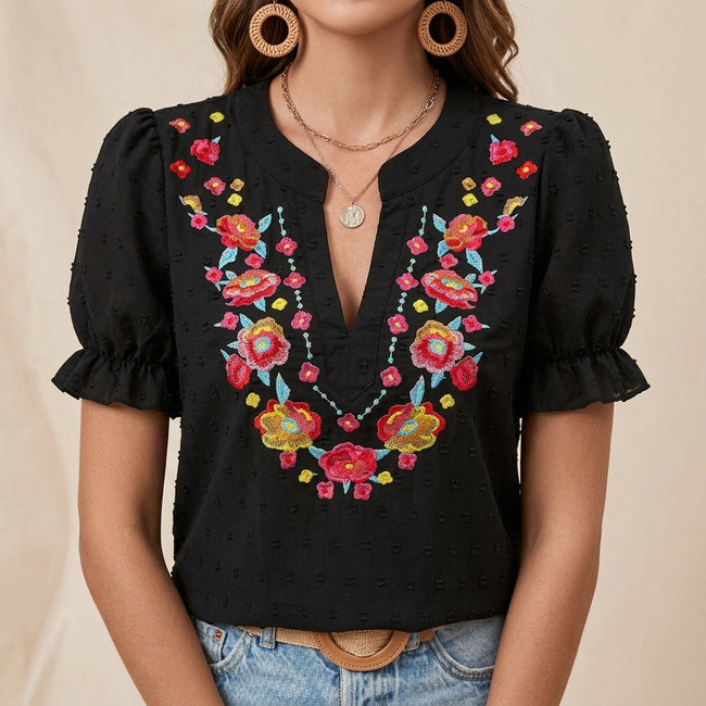 Black floral summer blouse for women with puff sleeves and ruffle details by FJØRNA, perfect for warm weather and casual wear.