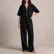 Black FJØRNA two-piece women's co-ord set with drawstring details, featuring a stylish crop top and matching pants.