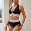 Black FJØRNA fitted halter bikini set for women, featuring a stylish halter top and matching bikini bottoms on a white background.