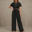 Black FJØRNA women's summer two-piece drawstring co-ord set with lightweight fabric, featuring a matching top and shorts.