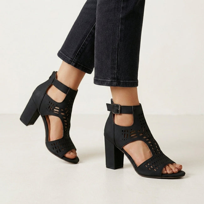 Black FJØRNA women's orthopedic heeled sandals with adjustable strap and buckle, showcasing stylish and supportive footwear.
