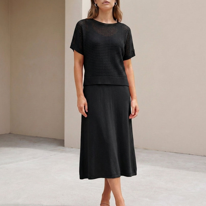 Black knit two-piece women's co-ord set by FJØRNA featuring a cropped top and matching high-waisted pants.