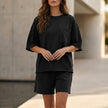 Black women's summer two-piece co-ord set by FJØRNA with pockets, lightweight fabric, perfect for casual warm-weather wear.