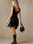 Black faux suede V-neck mini dress by FJØRNA, showing a casual sleeveless dress with a fitted silhouette and V-neckline.