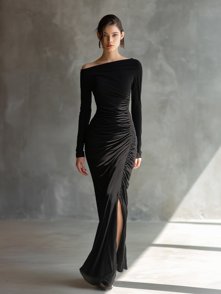 Black jersey ruched maxi dress by FJØRNA, featuring a fitted evening dress with elegant ruching and a flowing silhouette.
