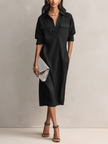 FJØRNA black linen midi dress for evening wear, featuring a fitted silhouette and elegant design perfect for formal occasions.