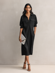 Black linen midi dress by FJØRNA, elegant evening dress with a flowing silhouette and subtle details.