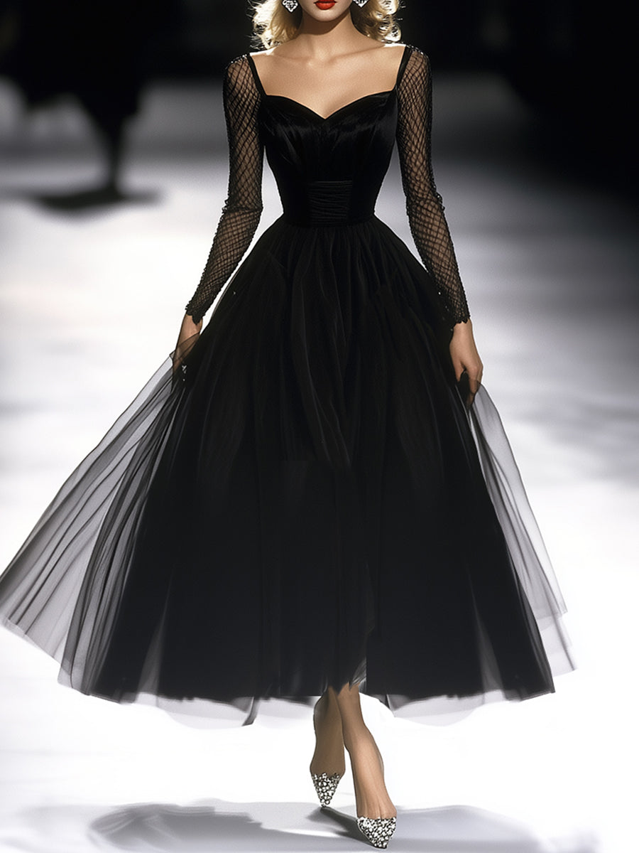 FJØRNA black maxi dress for women, flowing long dress with sleeveless design and elegant neckline, styled for a sophisticated look.