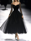 FJØRNA black maxi dress for women, flowing long dress with sleeveless design and elegant neckline, styled for a sophisticated look.