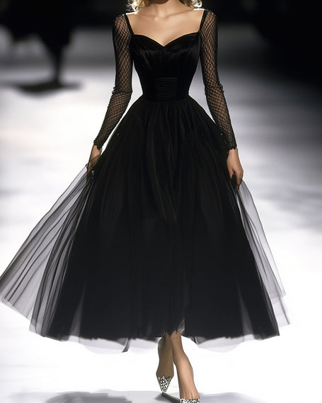 FJØRNA black maxi dress for women, flowing long dress with sleeveless design and elegant neckline, styled for a sophisticated look.