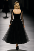 Black FJØRNA maxi dress for women, flowing fabric, sleeveless design, and ankle-length silhouette.