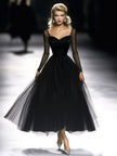 Black maxi dress for women by FJØRNA featuring a flowing silhouette and elegant design for versatile occasion wear.