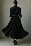 Black pleated maxi dress for women by FJØRNA, flowing fabric with a flattering silhouette and elegant pleats.