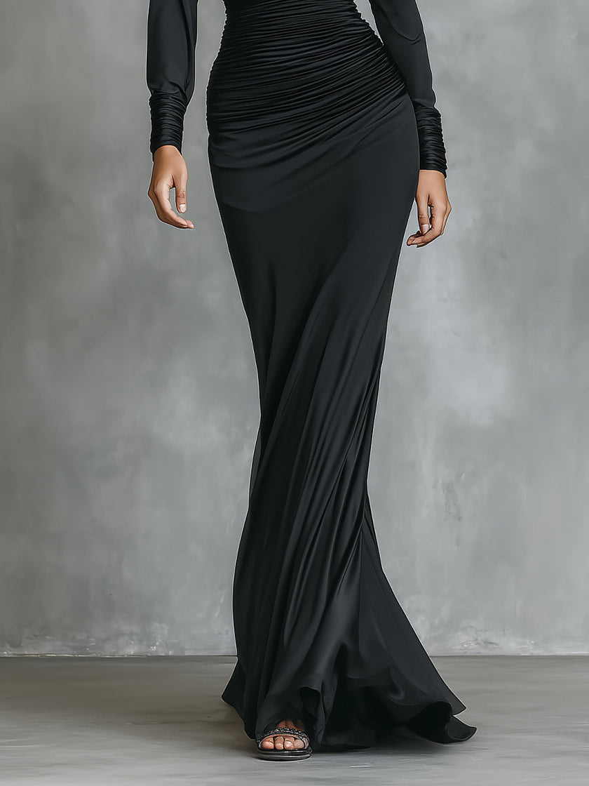 Black satin ruched maxi dress by FJØRNA, elegant evening dress with a fitted bodice and flowing skirt.