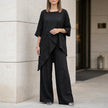Black women's summer two-piece asymmetric co-ord set by FJØRNA, featuring a stylish crop top and matching skirt.