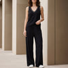 Black women's summer two-piece co-ord set with wide-leg pants and V-neck top by FJØRNA, shown on a model.