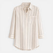 Women's striped button-down shirt by FJØRNA, relaxed fit, lightweight blouse with blue and white stripes.