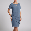 Blue elegant women's dress with ruffle chiffon design by FJØRNA, showcasing a flowing, stylish silhouette.