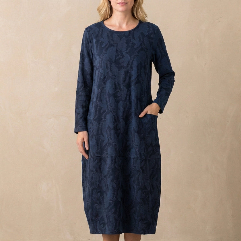 Blue FJØRNA elegant maxi dress for women with long sleeves and pockets, perfect for stylish daytime or evening wear.