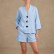Blue women's summer two-piece co-ord set with button front V-neck top and matching shorts by FJØRNA.