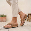 FJØRNA orthopedic open toe wedge flip-flops with floral embellishments, brown sandals with supportive design and decorative flower accents.