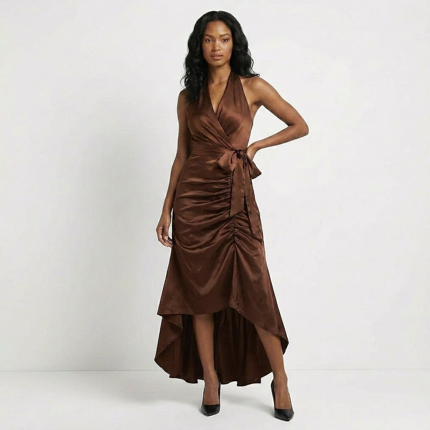 Brown FJØRNA elegant maxi dress for women with halter neck and ruffle satin fabric, flowing and stylish for special occasions.
