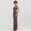 Side profile of FJØRNA women's strapless brown corset maxi dress showing fitted bodice and flowing skirt.