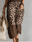 Brown knit leopard print maxi dress by FJØRNA, featuring a flowing silhouette and long sleeves, perfect for evening wear.